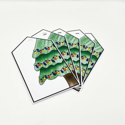 The Christmas Tree Gift Tag set includes five tags, each showcasing a beautifully decorated tree with multicolored lights arranged in a fan pattern on a white background. These tags are perfect for adding a festive touch to your gift wrap and are thoughtfully designed to complement your handmade holiday presents.