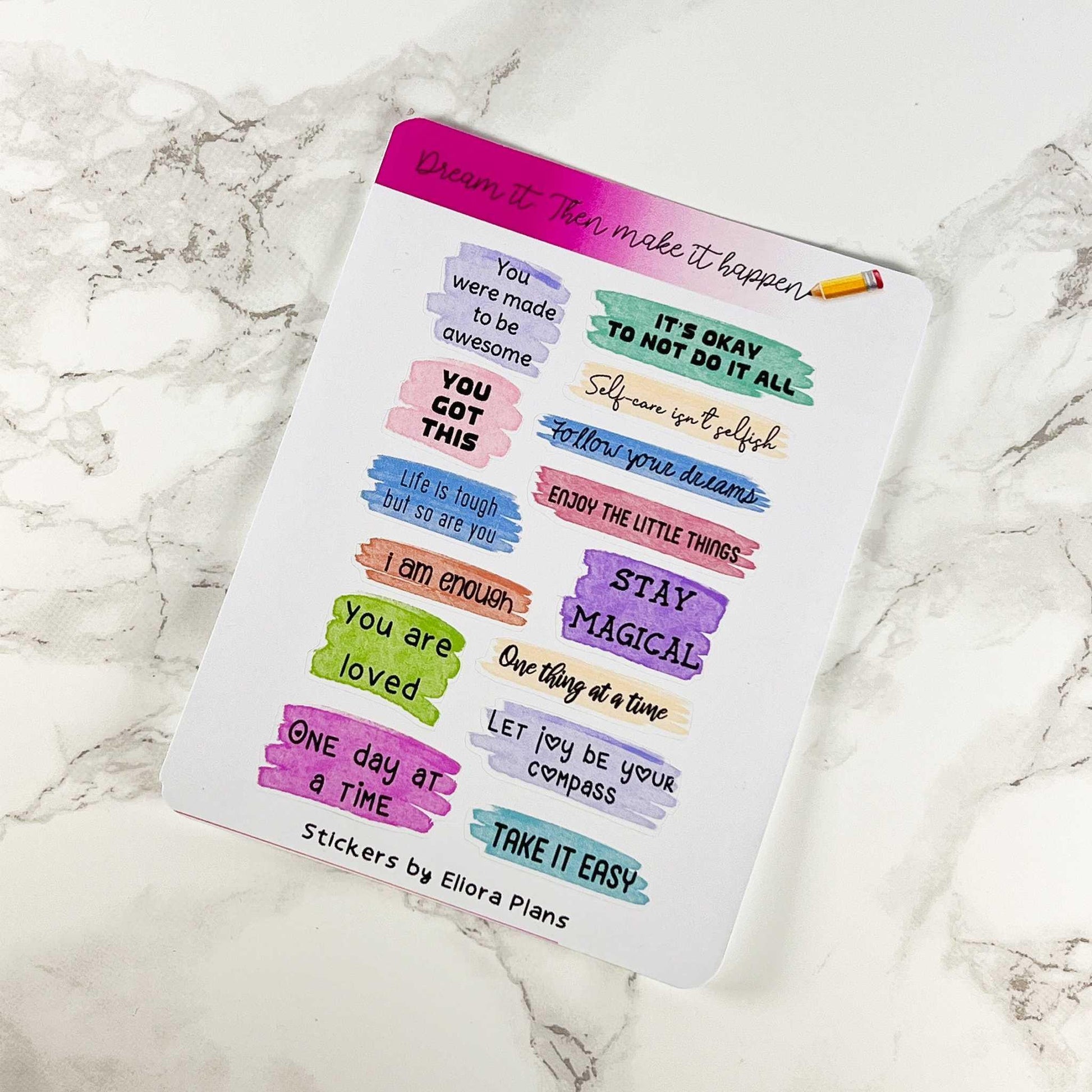 A decorated card on a marble surface displays various motivational quotes written in colorful text blocks, accompanied by a few stickers from the Self Affirmation Quotes Sticker Sheet - Not Quite Perfect Sticker Sheet.