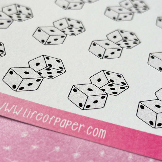 Dice Planner Stickers arranged in a pattern on a sheet of paper with a pink border; the paper includes the text "www.lifeofpaper.com".