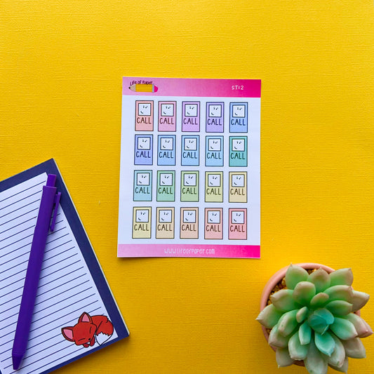 A brightly colored set of Call Reminder Planner Stickers on a yellow background. To the left of the Call Reminder Planner Stickers is an open lined diary with a purple pen resting on it, featuring a fox sticker. A green succulent in a small pot is placed to the right of the diary.

