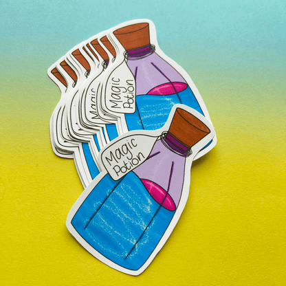 Magic Potion Stickers feature a bottle labeled "Magic Potion," filled with blue liquid and a pink section near the neck, arranged in a fanned-out stack against a gradient yellow and green background. Printed on strong matte vinyl, these stickers ensure they stand out wherever you place them.