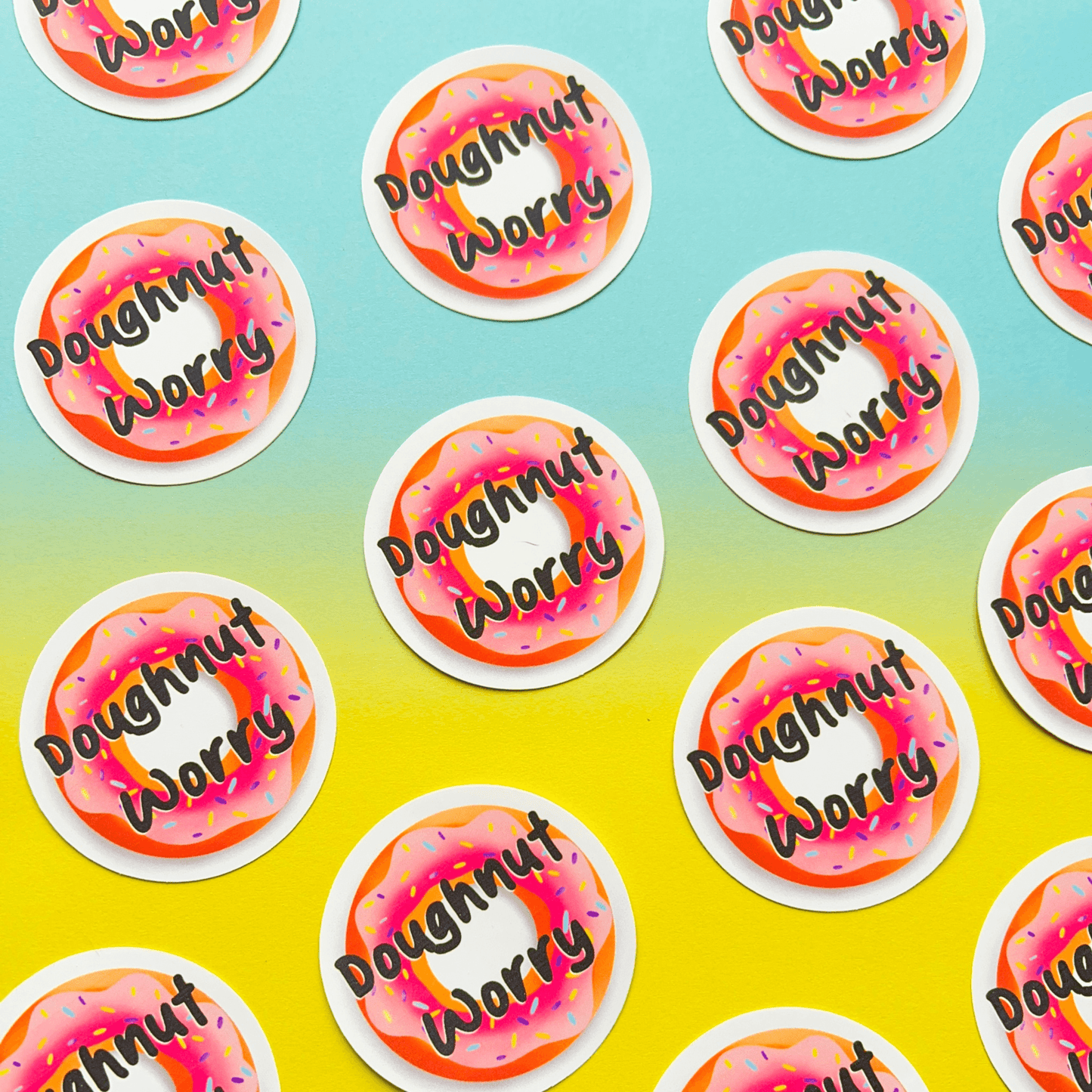 Introducing our Doughnut Sticker: Featuring a pink frosted doughnut with sprinkles and the phrase "Doughnut Worry" on a vibrant blue and yellow gradient background, crafted from durable matte vinyl.