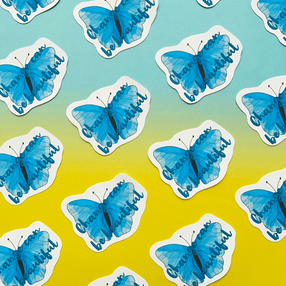 The "Change can be Beautiful Vinyl Sticker" features a blue butterfly and the text "Change can be beautiful," set against a gradient background that transitions from teal to yellow. These matte vinyl motivational stickers are perfect for adding an inspiring touch to your day.