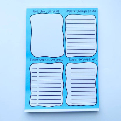 A Rainbow To Do List Desk Memo Pad with four sections labeled "Not that Urgent," "Quick things to do," "Time sensitive jobs," and "Super important." Each section has lines for writing tasks and is fountain pen friendly.