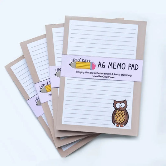 Four Owl Memo Pads with lined pages are displayed, each featuring an illustration of an owl in the lower-right corner. The fountain pen friendly pads are wrapped in a band labeled "Life of Paper" with a pencil graphic and the text "A6 MEMO PAD.